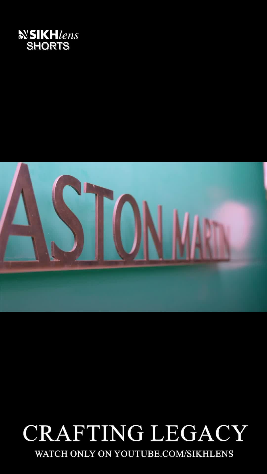 Aston Martin, in metal. He drew this badge before he worked under it.