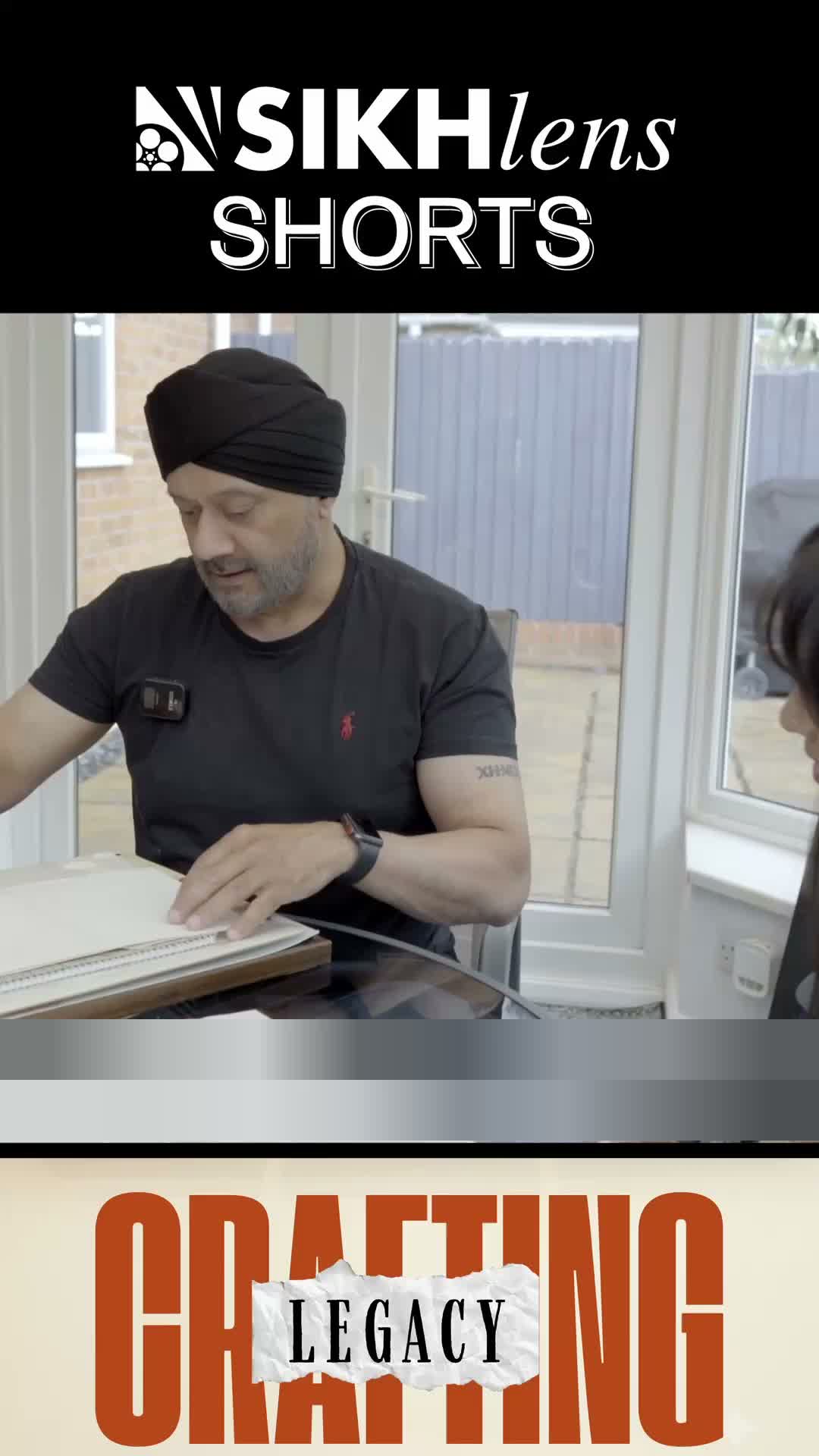 Still drawing. That is not a hobby in this film. That is the job.